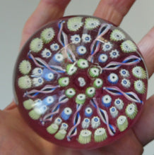 Load image into Gallery viewer, Vintage JOHN DEACONS Paperweight Cranberry Glass Ground, Millefiori Canes &amp; Nine Half Spokes. StK Cane
