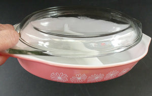 Two 1950s Vintage PYREX GAEITY Serving Dishes. One Oval Pink with Daisy Pattern. One Oblong Black Dish with Snowflake Pattern