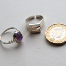 Load image into Gallery viewer, TWO Vintage Child&#39;s Size Silver Rings; One with the Initial &quot;E&quot; and the other (smaller) with an Amethyst.
