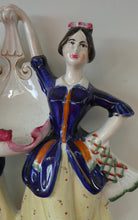 Load image into Gallery viewer, Antique Staffordshire Figurine. Pair of Scottish Lasses Dancing. Antique Ceramic Pocket Watch Holder
