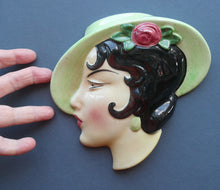 Load image into Gallery viewer, 1930s ART DECO Wall Mask by Cope &amp; Co. Art Deco Lady with Green Bonnet with Pink Flower. Black Hair
