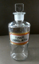 Load image into Gallery viewer, Larger Antique Clear Glass Chemist Bottle. TINCT: LOBEL: AETH with Original Foil Label and Lozenge Stopper

