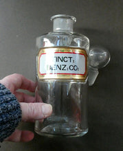 Load image into Gallery viewer, Large Antique Clear Glass Chemist Bottle. TINCT: BENZ: CO: with Original Foil Label and Ball Stopper
