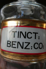 Load image into Gallery viewer, Large Antique Clear Glass Chemist Bottle. TINCT: BENZ: CO: with Original Foil Label and Ball Stopper
