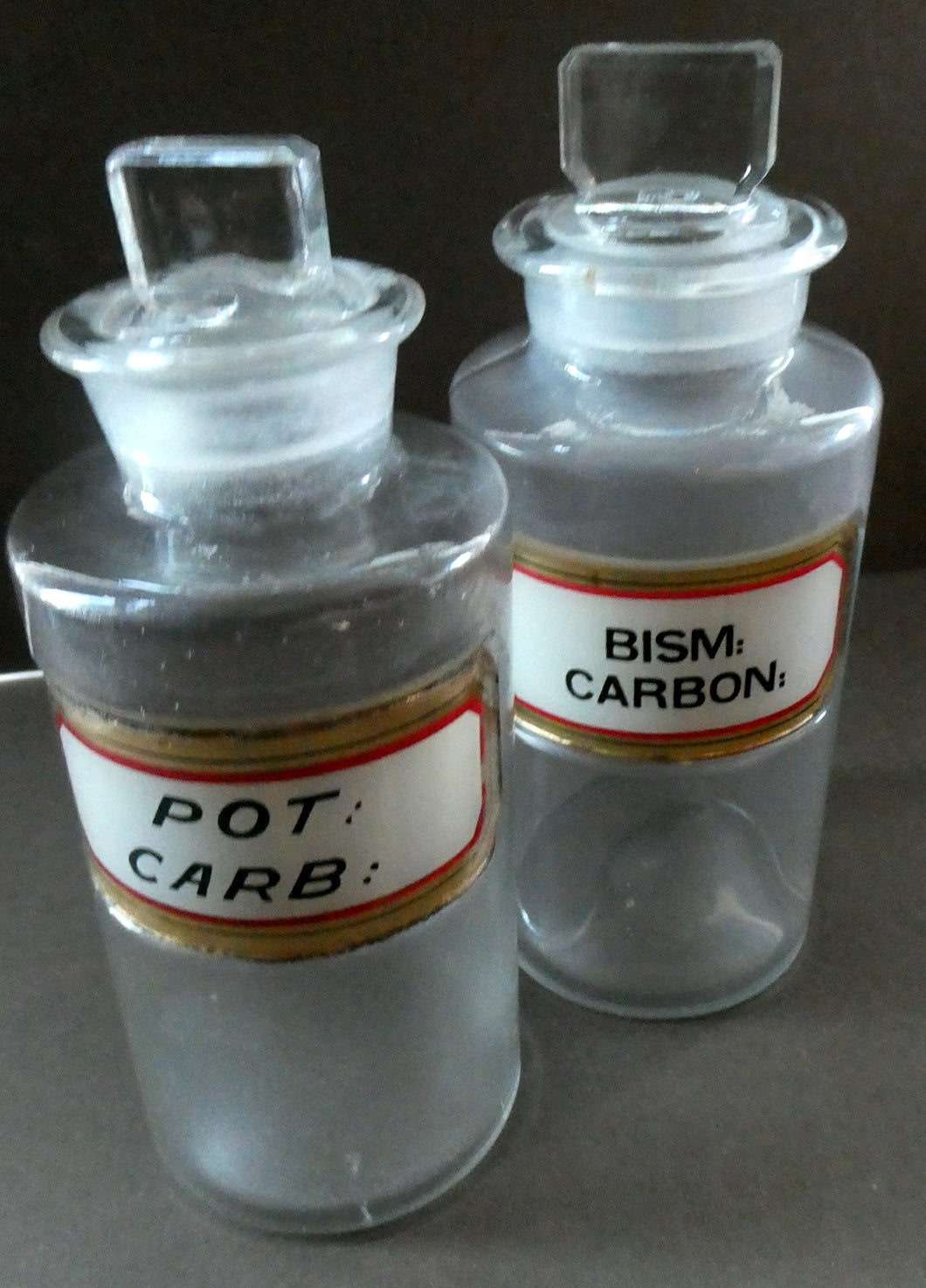 PAIR OF Larger Antique Clear Glass Chemist Bottles with Original Foil Labels and Lozenge Stoppers