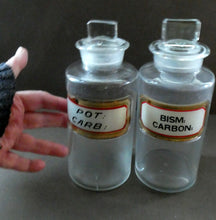 Load image into Gallery viewer, PAIR OF Larger Antique Clear Glass Chemist Bottles with Original Foil Labels and Lozenge Stoppers

