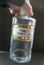 Load image into Gallery viewer, Larger Antique Clear Glass Chemist Bottle. TINCT: CENT: CO: with Original Foil Label and Lozenge Stopper
