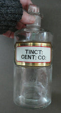 Load image into Gallery viewer, Larger Antique Clear Glass Chemist Bottle. TINCT: CENT: CO: with Original Foil Label and Lozenge Stopper
