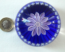 Load image into Gallery viewer, Scottish Paperweight by Peter McDougall Glass Studio. With Studio Cane on the Base with lilac lampwork flower 
