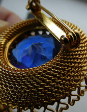 Load image into Gallery viewer, Vintage Costume Brooch with Heart Shapes on Rim and Blue Faceted Glass Insert
