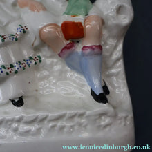 Load image into Gallery viewer, ANTIQUE Victorian 1880s Staffordshire Figurine. Courting Couple Sitting Underneath the Arch of a Bough Holding a Yellow Bird
