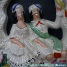 Load image into Gallery viewer, ANTIQUE Victorian 1880s Staffordshire Figurine. Courting Couple Sitting Underneath the Arch of a Bough Holding a Yellow Bird

