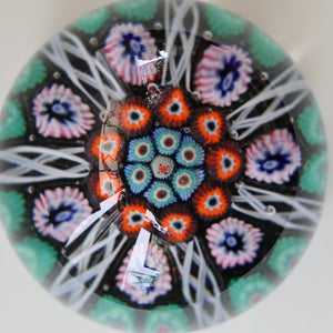 Fine VASART Scottish Glass Paperweight with 7 Short Spokes; with black ground, thick latticino spokes & larger millefiori canes