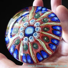 Load image into Gallery viewer, Fine VASART Scottish Glass Paperweight with 9 Spokes; with scarlet ground, latticino canes &amp; millefiore. 3 inches diameter
