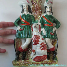 Load image into Gallery viewer, Antique Victorian Spill Vase Featuring a Pair of Huntsmen Wearing Short Green Tunics with a Large Dog
