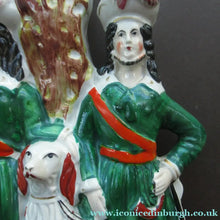 Load image into Gallery viewer, Antique Victorian Spill Vase Featuring a Pair of Huntsmen Wearing Short Green Tunics with a Large Dog
