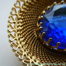 Load image into Gallery viewer, Vintage Costume Brooch with Heart Shapes on Rim and Blue Faceted Glass Insert
