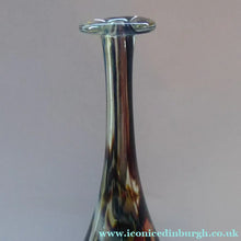 Load image into Gallery viewer, A tall, attenuated Mdina glass bottle vase with a tortoiseshell pattern and silvery trail decorations.
