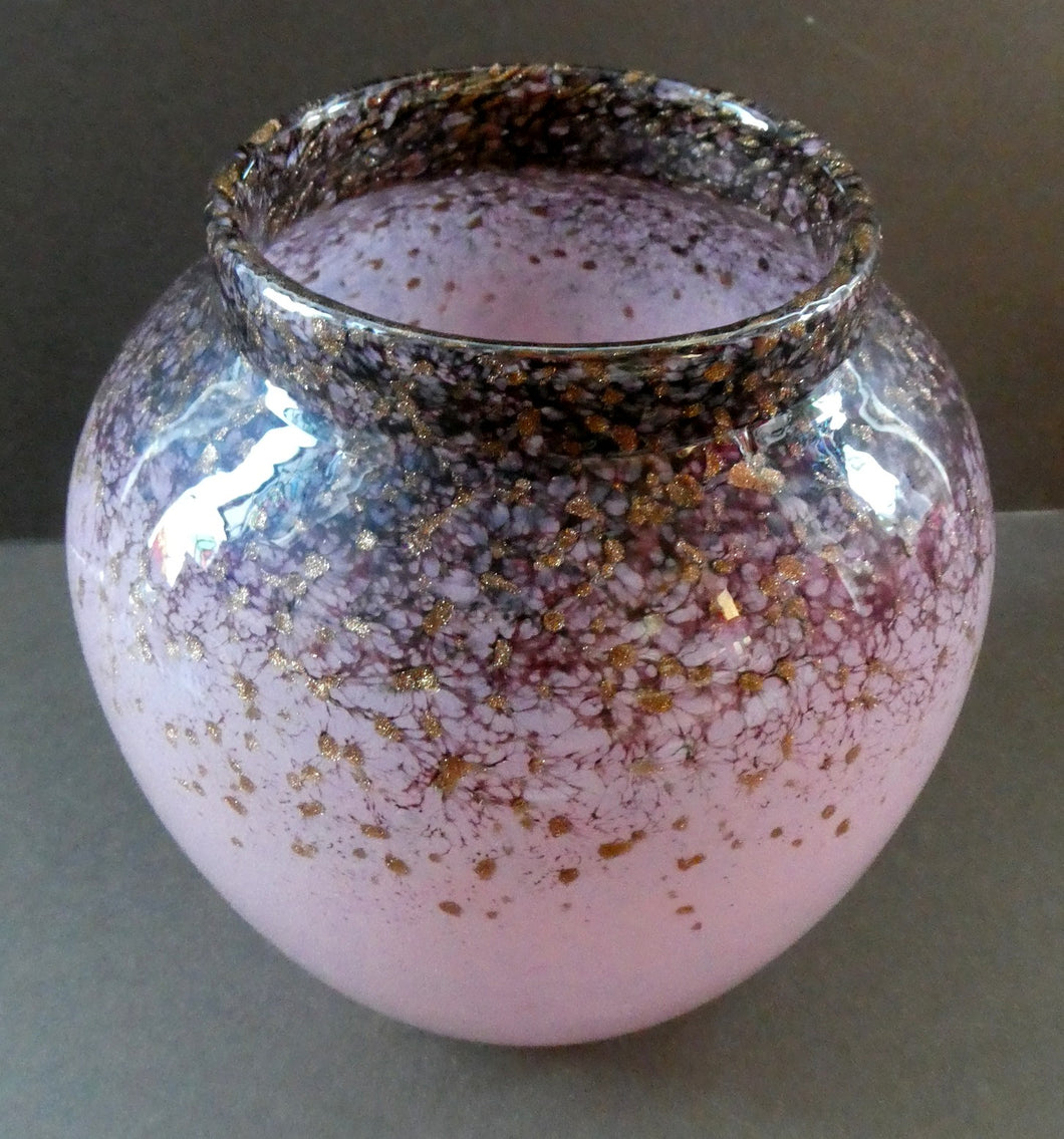 SCOTTISH GLASS. MONART Scottish Art Glass Vase. Bulbous Shape (A). Mottled Dusky Warm Pink with Black Flecks & Gold Aventurine at the Rim. 5 1/2 inches high