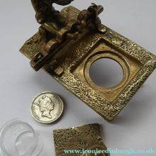 Load image into Gallery viewer, ANTIQUE INKWELL. An Extremely Rare Miniature Example Featuring a Little Man in Village Stocks Being Pelted with Fruit
