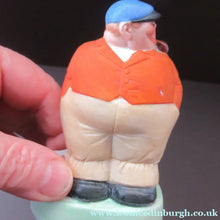 Load image into Gallery viewer, Porcelain Figure by Schafer &amp; Vater. Match Holder in the Form of a Man in an Orange Jacket: ON STRIKE
