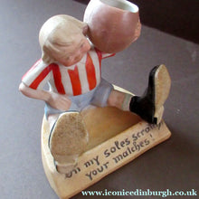 Load image into Gallery viewer, Antique Porcelain Match Holder &amp; Striker by Schafer &amp; Vater. FOOTBALLER HOLDING A FOOTBALL
