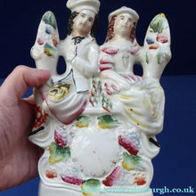 Load image into Gallery viewer, ANTIQUE Victorian Staffordshire Figurine. Poor Man's Clock. Two Highland Figures with Fruiting Vine
