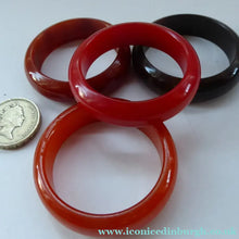 Load image into Gallery viewer, Set of Four Art Deco Bakelite Napkin Rings. Mostly Amber 1930s

