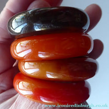 Load image into Gallery viewer, Set of Four Art Deco Bakelite Napkin Rings. Mostly Amber 1930s
