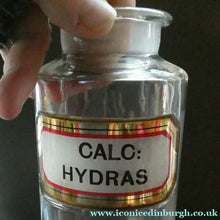Load image into Gallery viewer, Antique Clear Glass Chemist Bottle. CALC: HYDRAS with Original Foil Label and Lozenge Stopper

