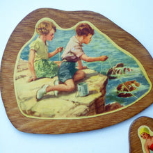 Load image into Gallery viewer, STRANGE 1950s Wooden Plate Mats - with Stylish Seaside or 1950s Beach Illustrations on each
