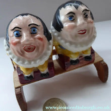 Load image into Gallery viewer, Vintage CRUET SET. Strange Novelty Ceramic Elizabethan Court Figures Sitting on a Wooden Bench
