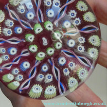 Load image into Gallery viewer, Vintage JOHN DEACONS Paperweight Cranberry Glass Ground, Millefiori Canes &amp; Nine Half Spokes. StK Cane
