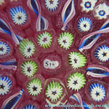 Load image into Gallery viewer, Vintage JOHN DEACONS Paperweight Cranberry Glass Ground, Millefiori Canes &amp; Nine Half Spokes. StK Cane
