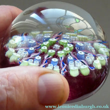 Load image into Gallery viewer, Vintage JOHN DEACONS Paperweight Cranberry Glass Ground, Millefiori Canes &amp; Nine Half Spokes. StK Cane
