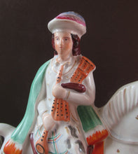 Load image into Gallery viewer, Antique Staffordshire on Scottish Horseman Playing the Bagpipes
