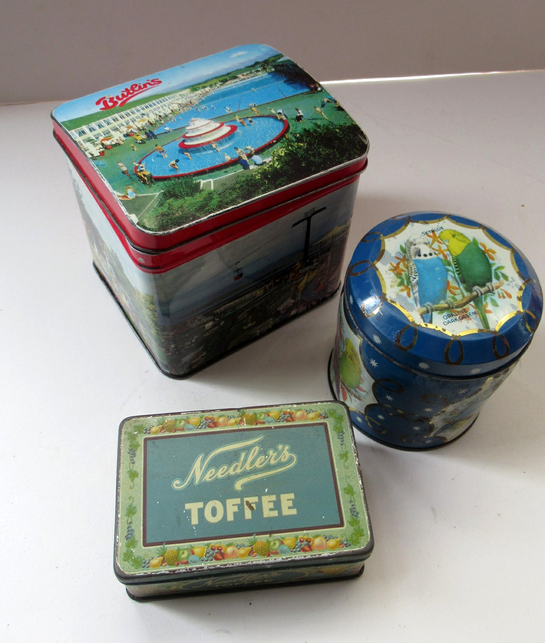 Three Vintage 1960s Advertising Tins. Butlins, Budgies and Needler's Toffee