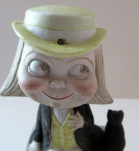 Load image into Gallery viewer, Antique Porcelain Nodder or Swinger Pin Tray by Schafer &amp; Vater. Boy Wearing Yellow Straw Hat with Black Cat
