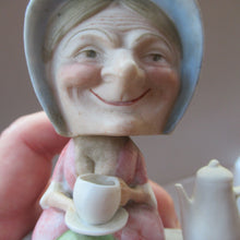 Load image into Gallery viewer, Antique Porcelain Nodder Figurine by Schafer &amp; Vater. Old Lady in Garden Drinking Tea 
