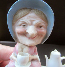 Load image into Gallery viewer, Antique Porcelain Nodder Figurine by Schafer &amp; Vater. Old Lady in Garden Drinking Tea 

