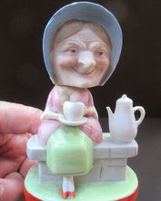 Load image into Gallery viewer, Antique Porcelain Nodder Figurine by Schafer &amp; Vater. Old Lady in Garden Drinking Tea 
