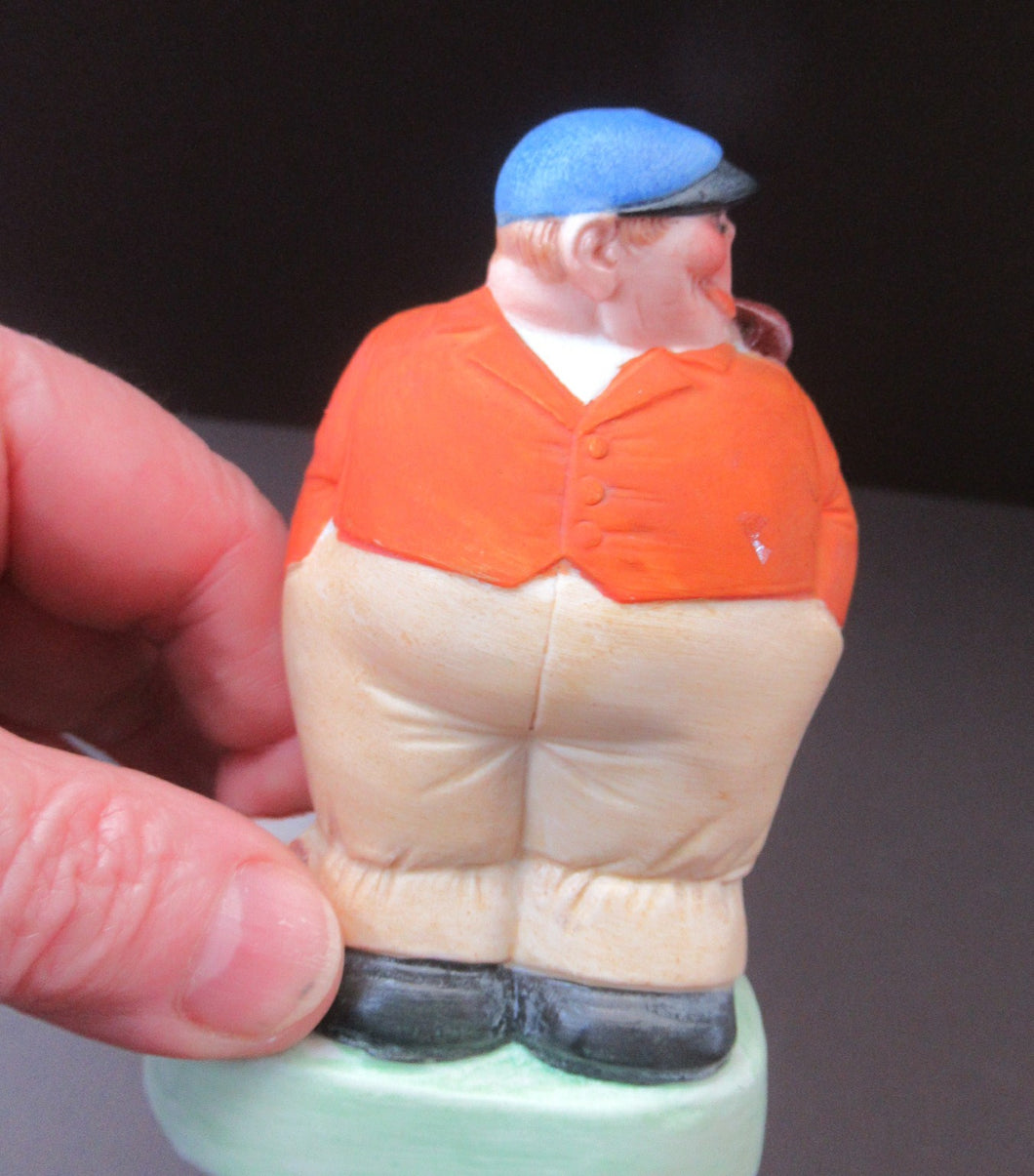 Porcelain Figure by Schafer & Vater. Match Holder in the Form of a Man in an Orange Jacket: ON STRIKE