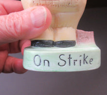 Load image into Gallery viewer, Porcelain Figure by Schafer &amp; Vater. Match Holder in the Form of a Man in an Orange Jacket: ON STRIKE
