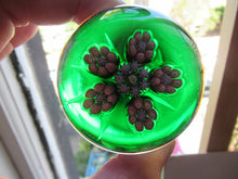 Load image into Gallery viewer, 1970s Perthshire Paperweight with Star-Shaped Clusters on Transluscent Emerald Green Base
