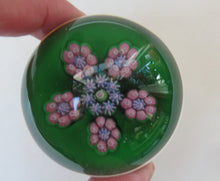 Load image into Gallery viewer, 1970s Perthshire Paperweight with Star-Shaped Clusters on Transluscent Emerald Green Base
