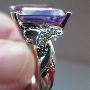 Pretty 9 CT White Gold Ring Set with an Emerald Cut Amethyst & flanked with decorative diamond chips. Size N 1/2
