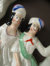 Load image into Gallery viewer, Antique Staffordshire Flatback Figurine. Courting Couple Sitting Under a Bough
