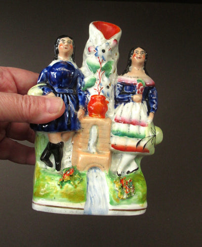 Antique Staffordshire Miniature Spill Vase. A Courting Couple Standing at a Well over a Stream