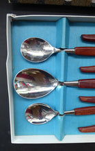 Load image into Gallery viewer, Vintage 1960s GLOSSWOOD Cutlery. Stainless Steel Six Dessert Spoons &amp; Larger Serving Spoon with Teak Effect Handles. Original Retail Box
