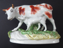 Load image into Gallery viewer, ANTIQUE STAFFORDSHIRE Figurine. Large Cow with her White Calf on Raised Oval Base; 1880s
